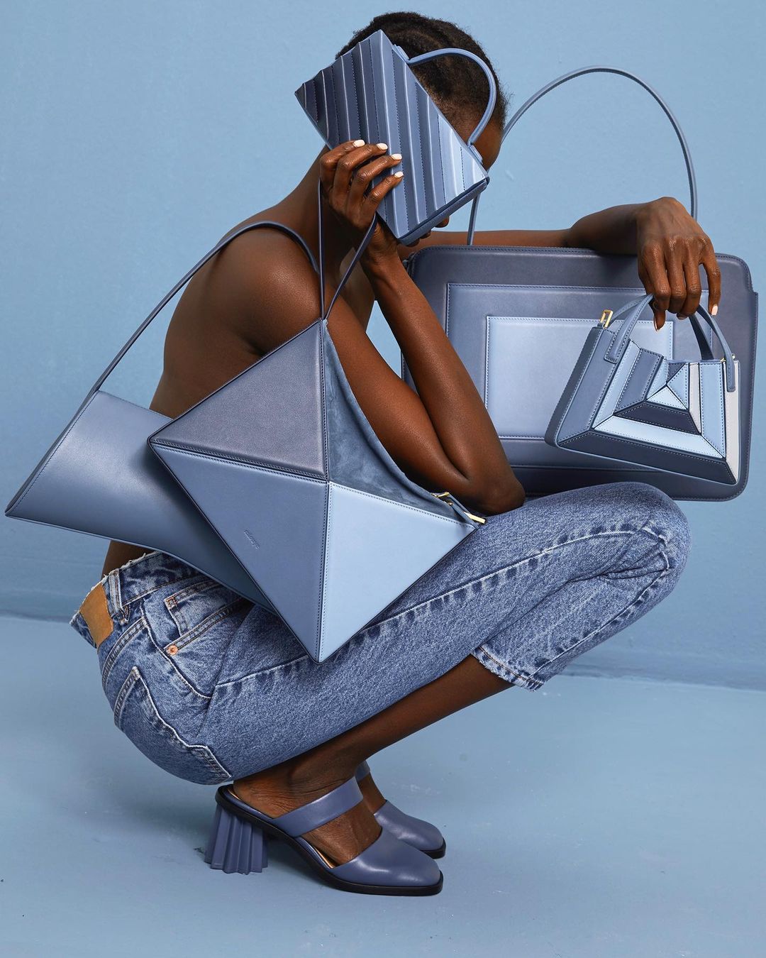 Studio campaign: model with blue handbags
