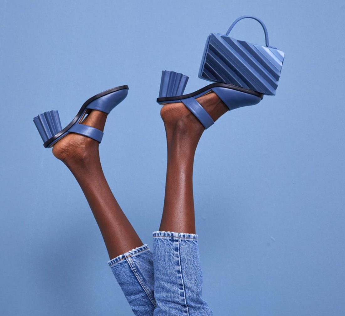 Studio detail: feet and blue handbag